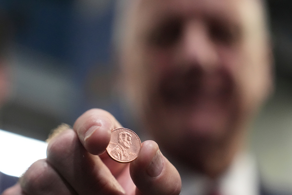 U.S. Treasurer Brandon Beach holds one of the last pennies pressed at the U.S. Mint in Philadelphia, Wednesday, Nov. 12, 2025. (AP Photo/Matt Slocum)