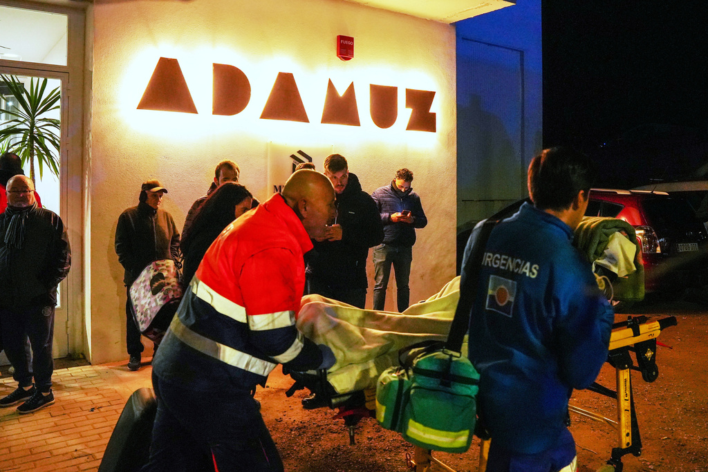 An injured person is transported to the makeshift hospital in the sports center in Adamuz, near Córdoba, southern Spain, Monday, Jan. 19, 2026, after a high-speed train derailed and collided with another train. (Francisco J. Olmo/Europa Press via AP)