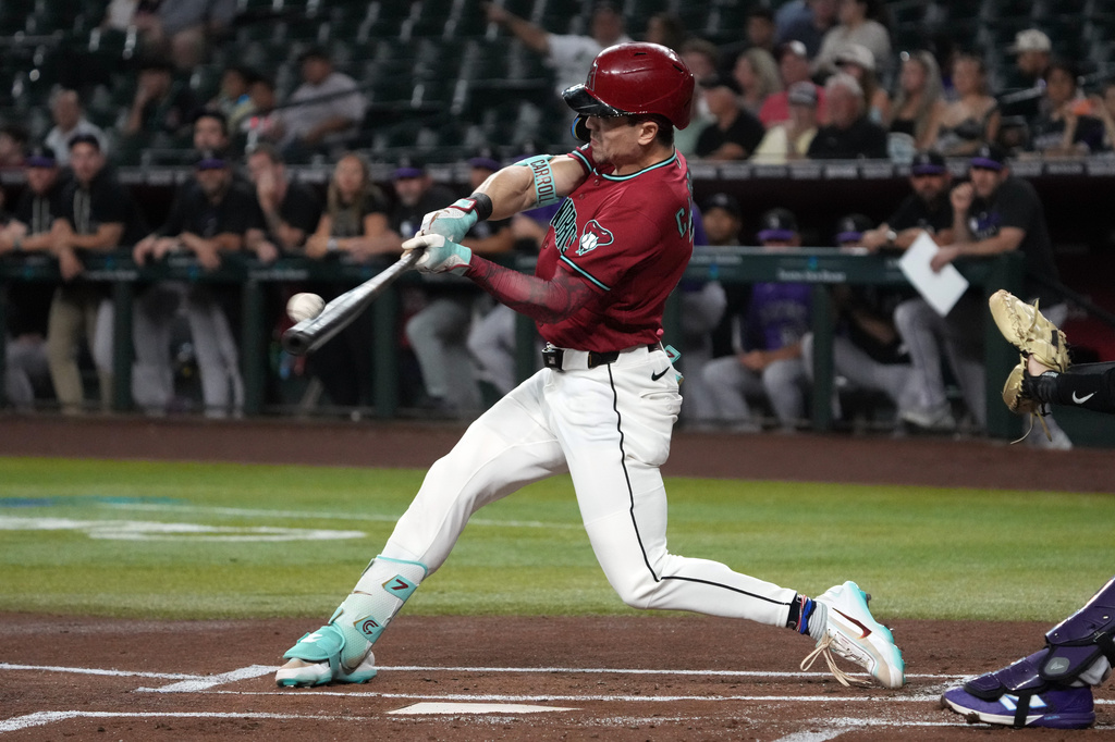 Arizona Diamondbacks' Corbin Carroll hits a solo home run against the Colorado Rockies in the first inning of a baseball game, Tuesday, Aug. 11, 2026, in Phoenix. (AP Photo/Rick Scuteri)
