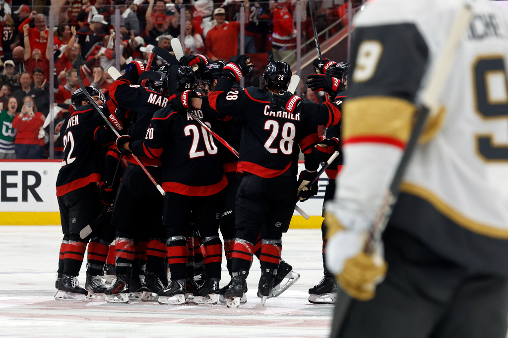 Carolina Hurricanes players celebrate after the winning goal by Seth Jarvis following the overtime period in Game 2 of the NHL hockey Stanley Cup Final series against the Vegas Golden Knights in Raleigh, N.C., Thursday, June 4, 2026. (AP Photo/Karl DeBlaker)