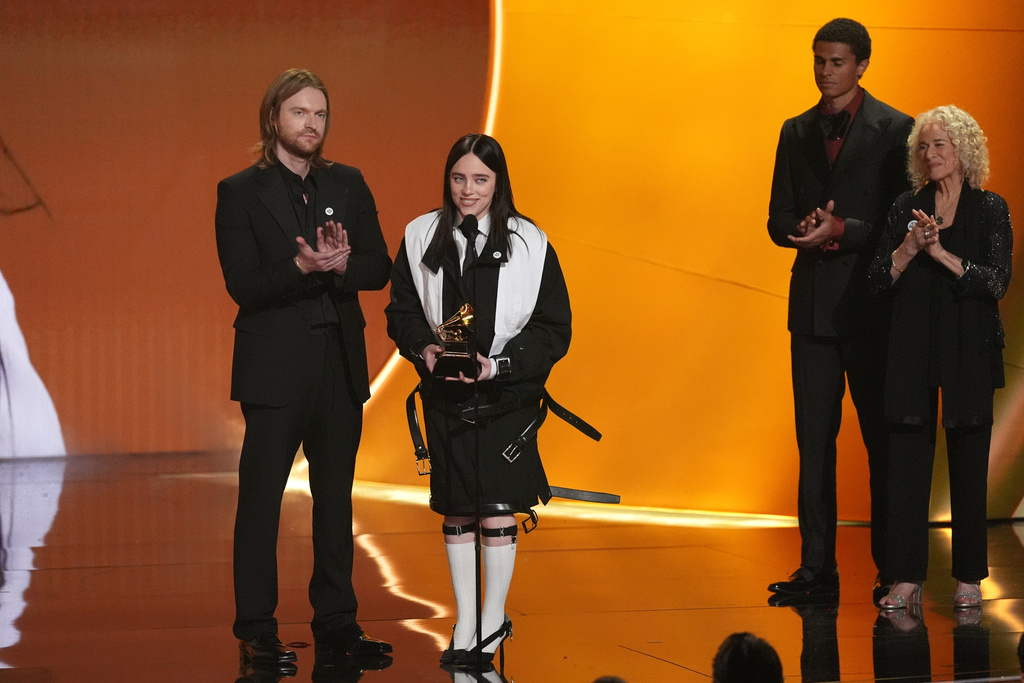 Finneas, left, and Billie Eilish accept the award for song of the year for "Wildflower" during the 68th annual Grammy Awards on Sunday, Feb. 1, 2026, in Los Angeles. Carole King looks on from right. (AP Photo/Chris Pizzello)