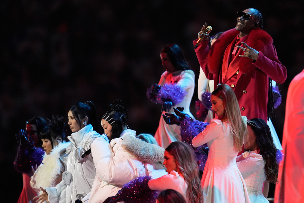 Snoop Dogg performs with HUNTR/X during halftime of an NFL football game between the Minnesota Vikings and the Detroit Lions, Thursday, Dec. 25, 2025, in Minneapolis. (AP Photo/Abbie Parr)