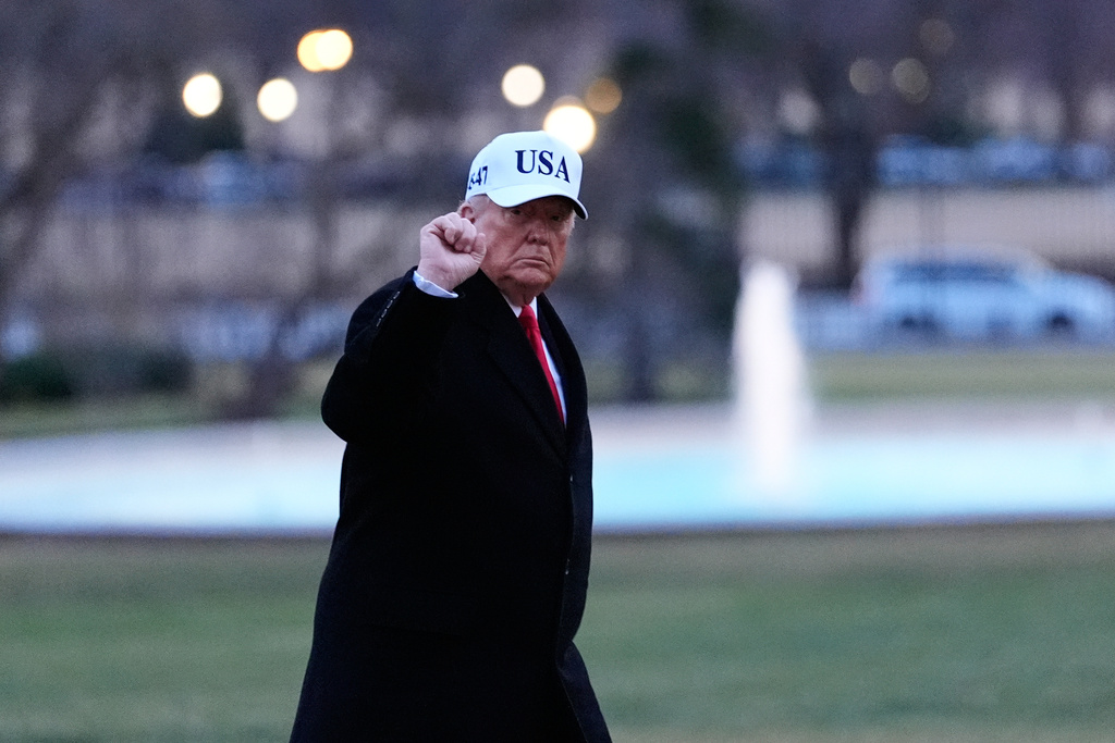 President Donald Trump gestures as he walks from Marine One after arriving on the South Lawn of the White House, Tuesday, Jan. 13, 2026, in Washington. (AP Photo/Alex Brandon)