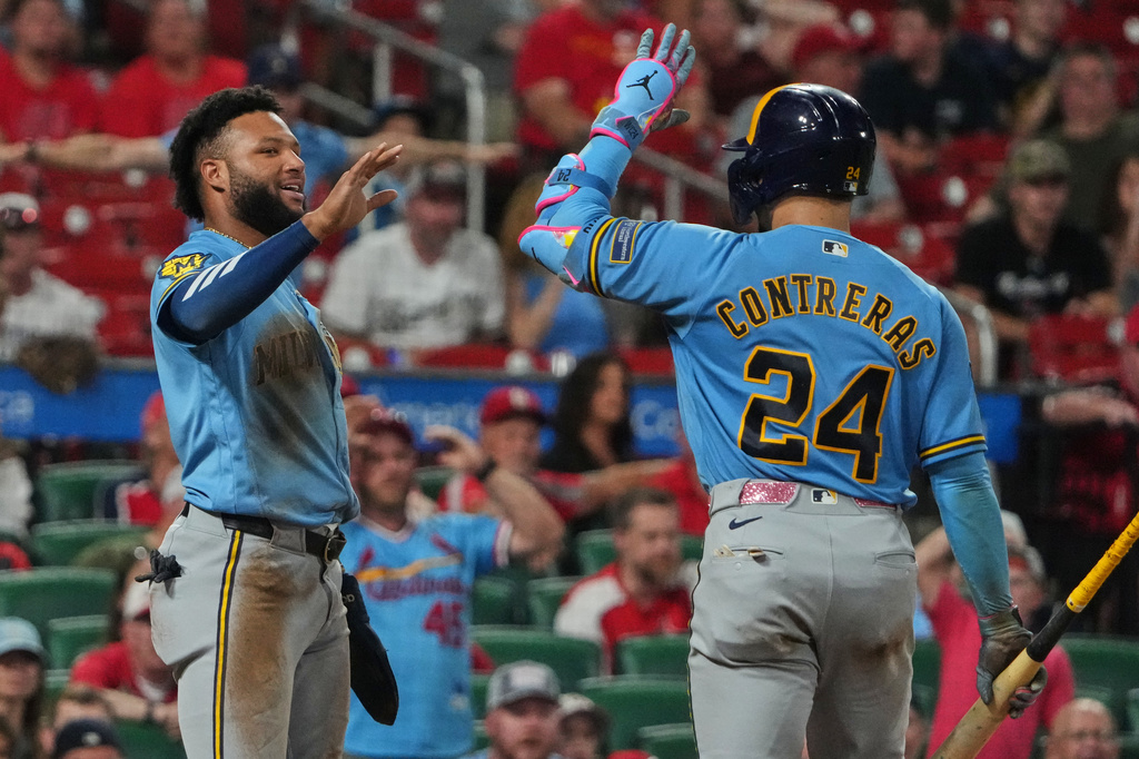 Milwaukee Brewers' Jackson Chourio, left, is congratulated by teammate William Contreras (24) after scoring during the ninth inning of a baseball game Thursday, July 9, 2026, in St. Louis. (AP Photo/Jeff Roberson)