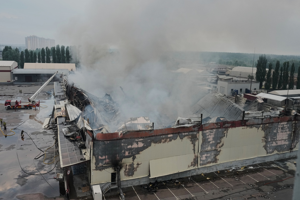 Firefighters put out a fire after Russian missiles hit a food warehouse near Kyiv, Ukraine, Wednesday, Aug. 5, 2026. (AP Photo/Efrem Lukatsky)