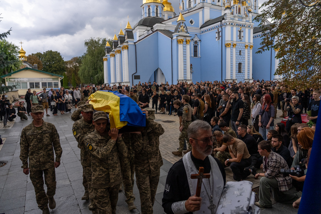 Ukrainian servicemen carry the coffin of fallen soldier Danyil Smyrnov, 21, who was killed on the frontline, during the funeral ceremony in Kyiv, Ukraine, Thursday, Sept. 3, 2026. (AP Photo/Alex Babenko)