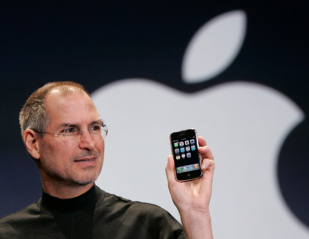 FILE - Apple CEO Steve Jobs holds up an Apple iPhone at the MacWorld Conference, Jan. 9, 2007, in San Francisco. (AP Photo/Paul Sakuma, File)