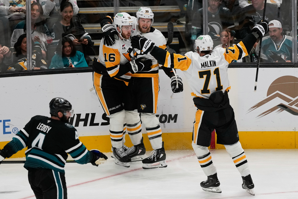 Pittsburgh Penguins right wing Anthony Mantha, middle, is congratulated by right wing Justin Brazeau (16) and center Evgeni Malkin (71) after scoring against the San Jose Sharks during the third period of an NHL hockey game in San Jose, Calif., Saturday, Oct. 18, 2025. (AP Photo/Jeff Chiu)
