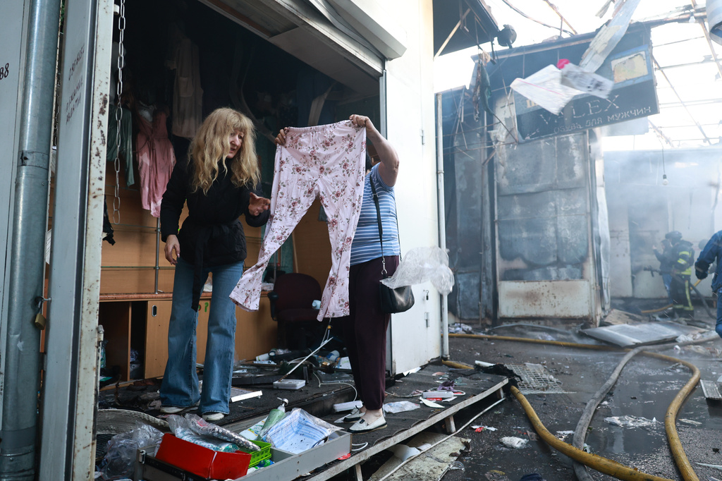 A seller checks clothes at the central market damaged in a Russian strike on Zaporizhzhia, Ukraine, on Saturday, Sept.26, 2026. (AP Photo/Kateryna Klochko)