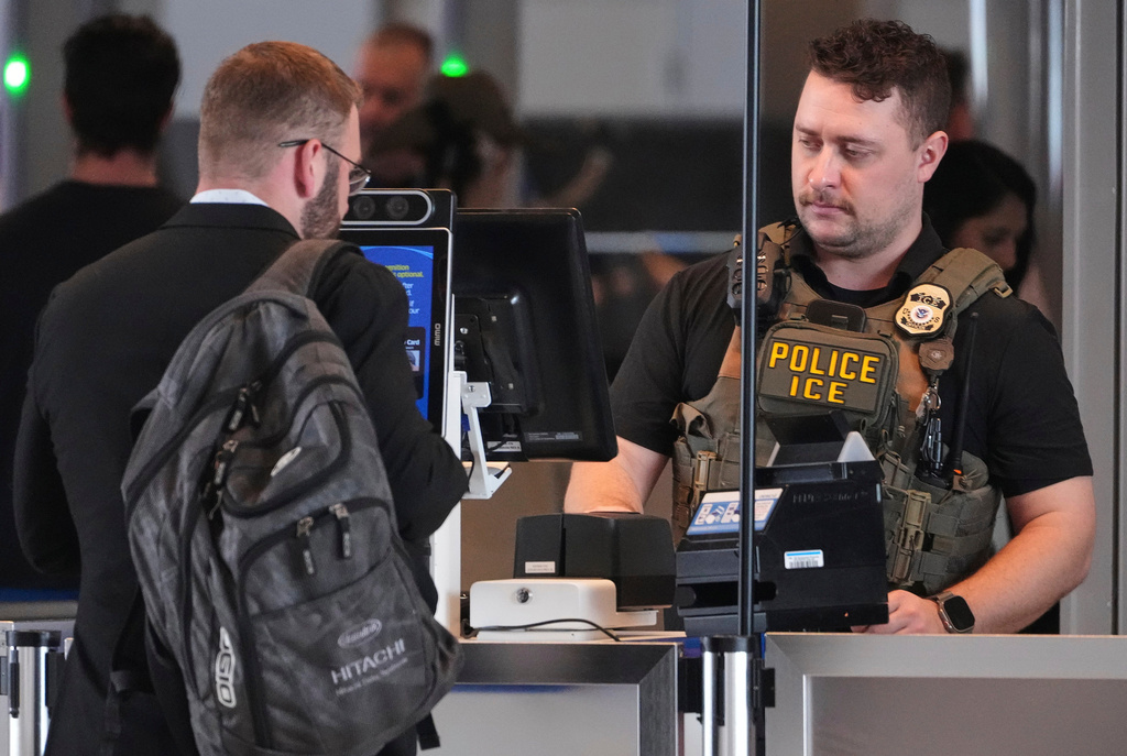 An ICE officer works at a TSA checkpoint at Pittsburgh International Airport in Imperial, Pa., on Thursday, March 26, 2026. (AP Photo/Gene J. Puskar)