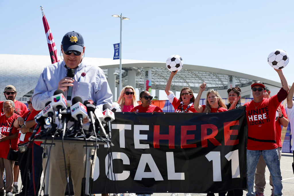 Food and beverage workers cheer during a news conference in front of Sofi Stadium Tuesday, Jun. 9, 2026 in Inglewood, Calif. (AP Photo/Ryan Sun)