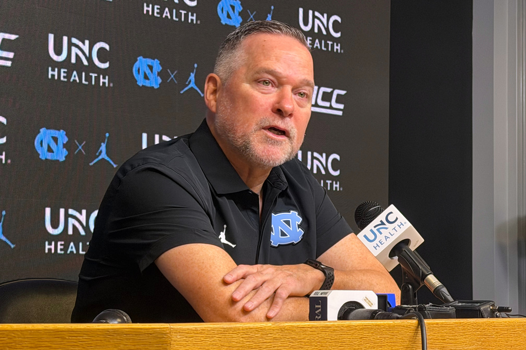 In this photo taken with a smartphone, North Carolina men's basketball head coach Michael Malone speaks during a news conference Thursday, Sept. 3, 2026, in Chapel Hill, N.C. (AP Photo/Aaron Beard)