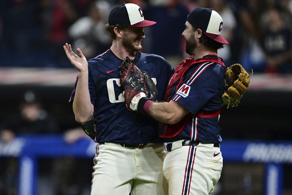 Cleveland Guardians starting pitcher Tanner Bibee, left, is congratulated by catcher Austin Hedges after the Guardians defeated the Chicago White Sox in a baseball game, Friday, Sept. 12, 2025, in Cleveland. (AP Photo/David Dermer)