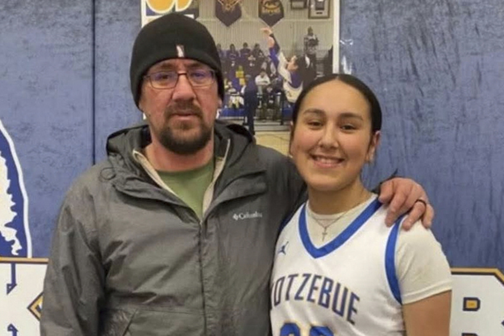 In this 2025 photo provided by Jimmy Brown, his brother Elmer Brown, left, poses for a photo with his daughter Elizabeth at the high school in Kotzebue, Alaska. Elmer Brown died in November 2025 of hypothermia after falling through the ice while hunting caribou. (Courtesy of Jimmy Brown via AP)