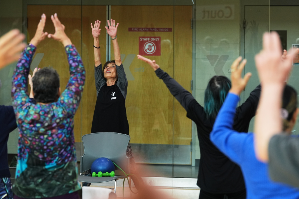 Instructor Bengie Santos, 72, leads a class for older adults at the Dale Turner Family YMCA, April 30, 2026, in Shoreline, Wash. (AP Photo/Lindsey Wasson)
