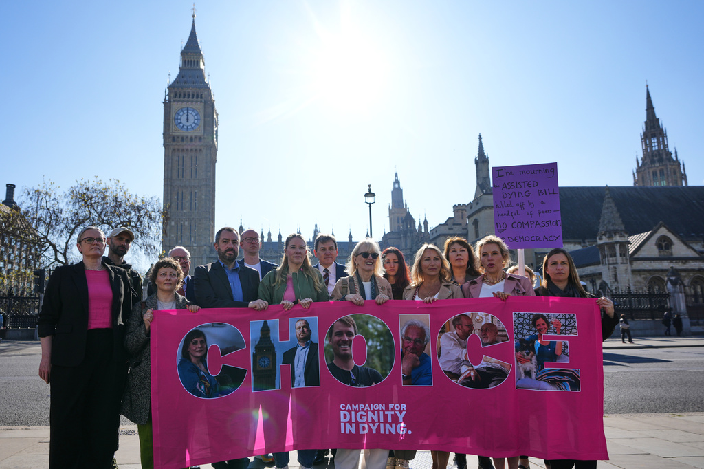 Campaigners hold a banner outside parliament in London as a proposed law to legalise assisted dying in England and Wales will run out of time on Friday, more than a year after MPs first voted in favour of it, Friday, April 24, 2026. (AP Photo/Kirsty Wigglesworth)