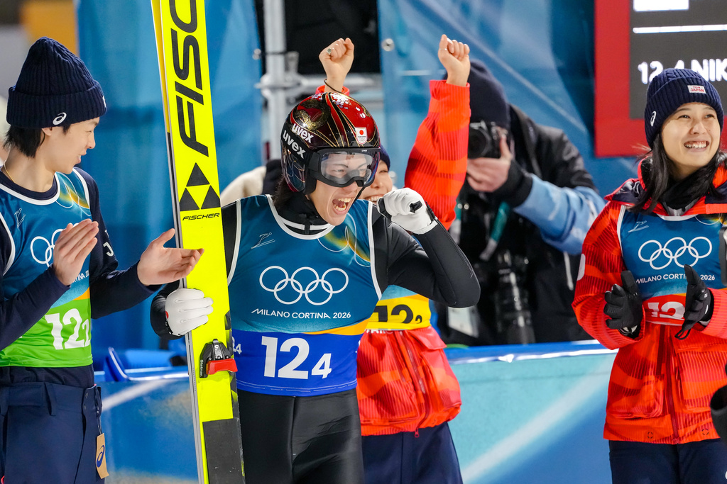 Ren Nikaido, of Japan, reacts after his final round jump during the ski jumping mixed team competition at the 2026 Winter Olympics, in Predazzo, Italy, Tuesday, Feb. 10, 2026. (AP Photo/Kirsty Wigglesworth)