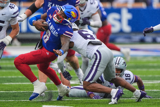 Kansas quarterback Jalon Daniels, left, is tackled by Kansas State safety Qua Moss, right, during the first half of an NCAA college football game Saturday, Oct. 25, 2025, in Lawrence, Kan. (AP Photo/Charlie Riedel) Kansas quarterback Jalon Daniels, left, is tackled by Kansas State safety Qua Moss, right, during the first half of an NCAA college football game Saturday, Oct. 25, 2025, in Lawrence, Kan. (AP Photo/Charlie Riedel)