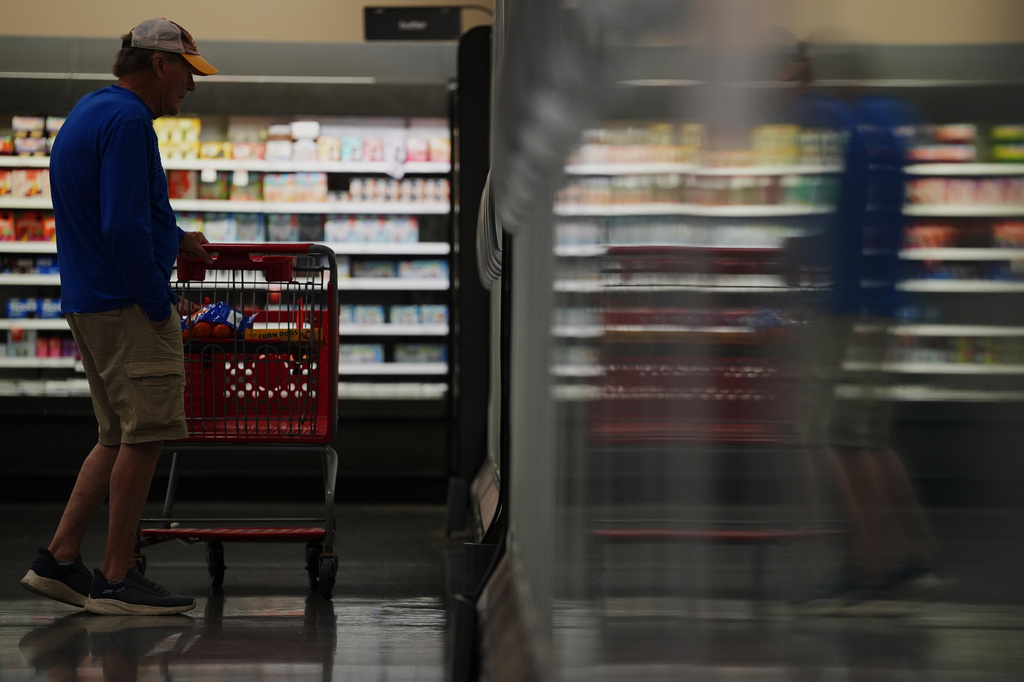 A shopper browses the frozen aisle at a Target store, Thursday, Aug. 13, 2026, in Woodbury, Minn. (AP Photo/Ellen Schmidt)