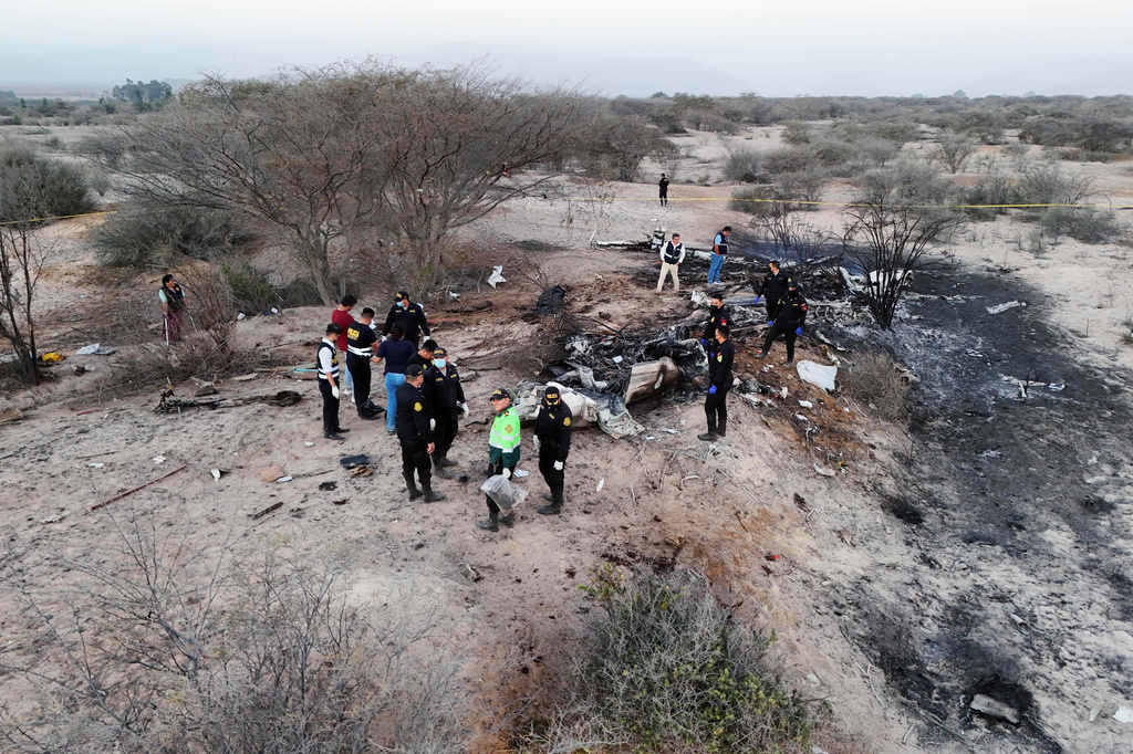 Police inspect the wreckage of a plane that crashed during a sightseeing flight carrying tourists over the Nazca Lines in Peru, Saturday, Aug. 1, 2026. (AP Photo/Genry Bautista)