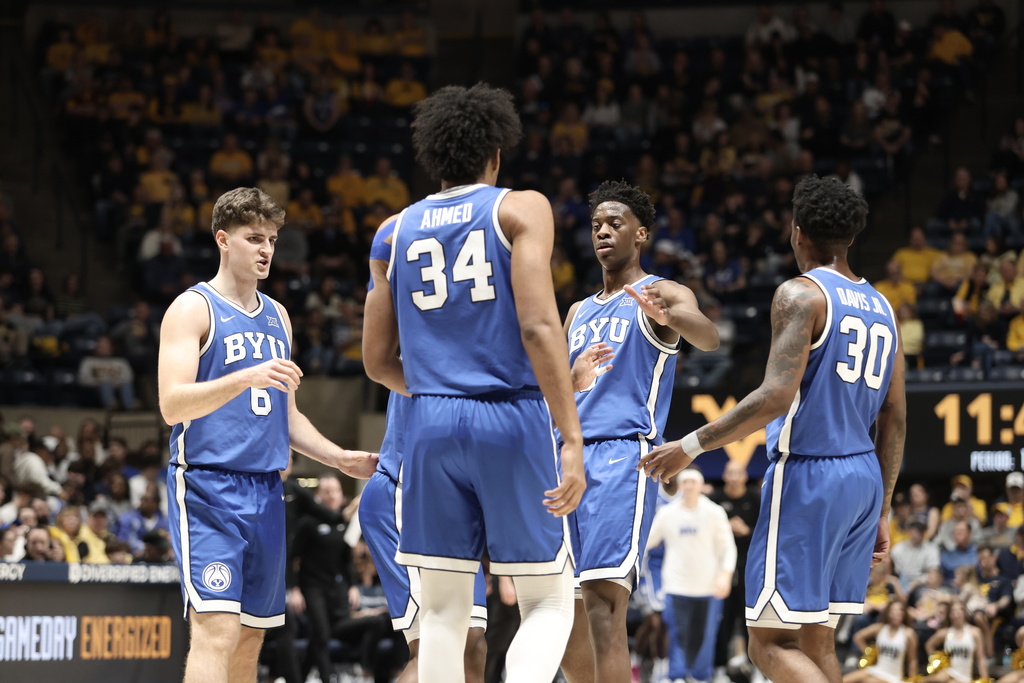 BYU players meet on the court during the first half of an NCAA college basketball game against West Virginia Saturday, Feb. 28, 2026, in Morgantown, W.Va. (AP Photo/Kathleen Batten)
