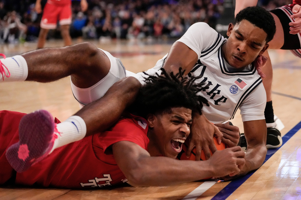 Duke guard Caleb Foster (1) fights for control of the ball with Texas Tech guard Christian Anderson (4) during the second half of an NCAA college basketball game, Saturday, Dec. 20, 2025, in New York. (AP Photo/Yuki Iwamura)