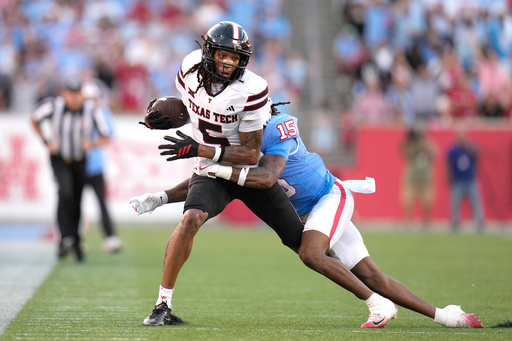 Texas Tech wide receiver Caleb Douglas (5) is tackled by Houston defensive back Will James (15) after catching a pass during the first half of an NCAA college football game, Saturday, Oct. 4, 2025, in Houston. (AP Photo/Karen Warren) Texas Tech wide receiver Caleb Douglas (5) is tackled by Houston defensive back Will James (15) after catching a pass during the first half of an NCAA college football game, Saturday, Oct. 4, 2025, in Houston. (AP Photo/Karen Warren)