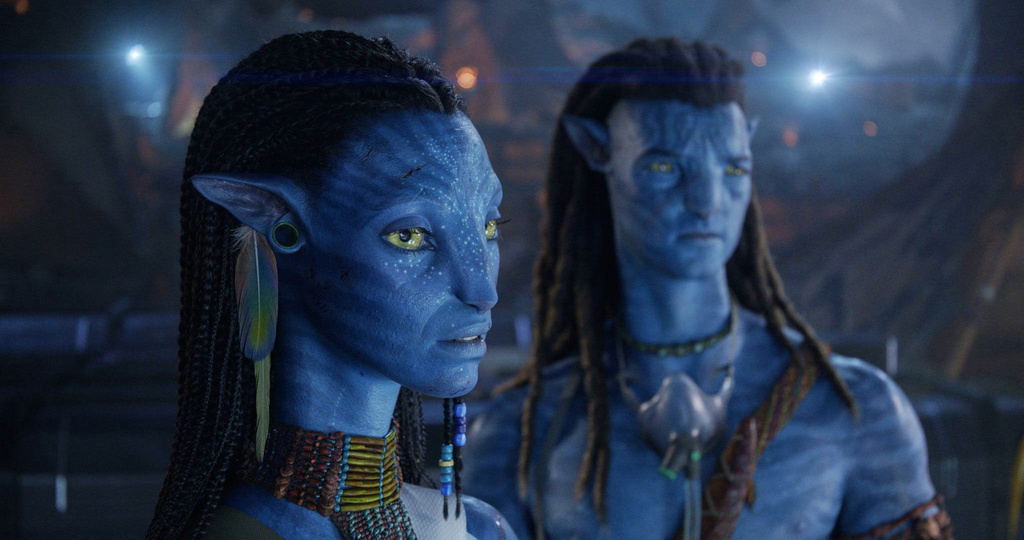 This image released by 20th Century Studios shows Neytiri, performed by Zoe Saldaña, left, and Jake Sully, performed by Sam Worthington, in a scene from "Avatar: Fire and Ash." (20th Century Studios via AP)
