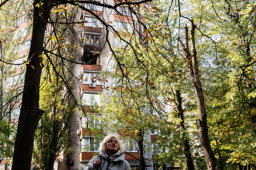 A woman looks at damage to an apartment building following Russian attacks, Wednesday, Oct. 22, 2025, in Kyiv, Ukraine. (AP Photo/Julia Demaree Nikhinson) A woman looks at damage to an apartment building following Russian attacks, Wednesday, Oct. 22, 2025, in Kyiv, Ukraine. (AP Photo/Julia Demaree Nikhinson)