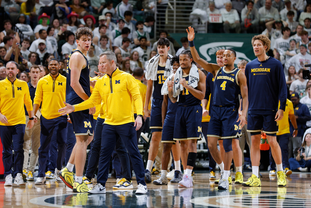 The Michigan bench reacts during the second half of an NCAA college basketball game against Michigan State, Friday, Jan. 30, 2026, in East Lansing, Mich. (AP Photo/Al Goldis)