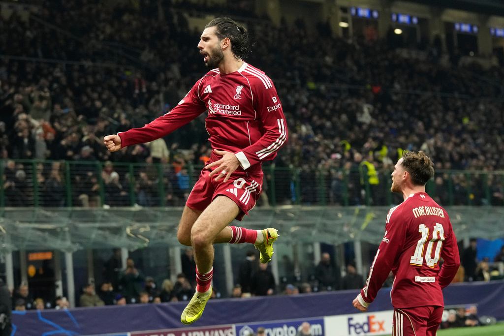 Liverpool's Dominik Szoboszlai celebrates after scoring his side's first goal from a penalty shot during a Champions League, league phase, soccer match between Inter Milan and Liverpool in Milan, Italy, Tuesday, Dec.9, 2025. (AP Photo/Luca Bruno)
