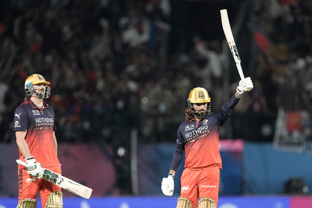 Royal Challengers Bengaluru's captain Rajat Patidar, right, celebrates his fifty runs during the Indian Premier League cricket match between Gujarat Titans and Royal Challengers Bengaluru in Dharamshala, India, Tuesday, May 26, 2026. (AP Photo/Ashwini Bhatia)