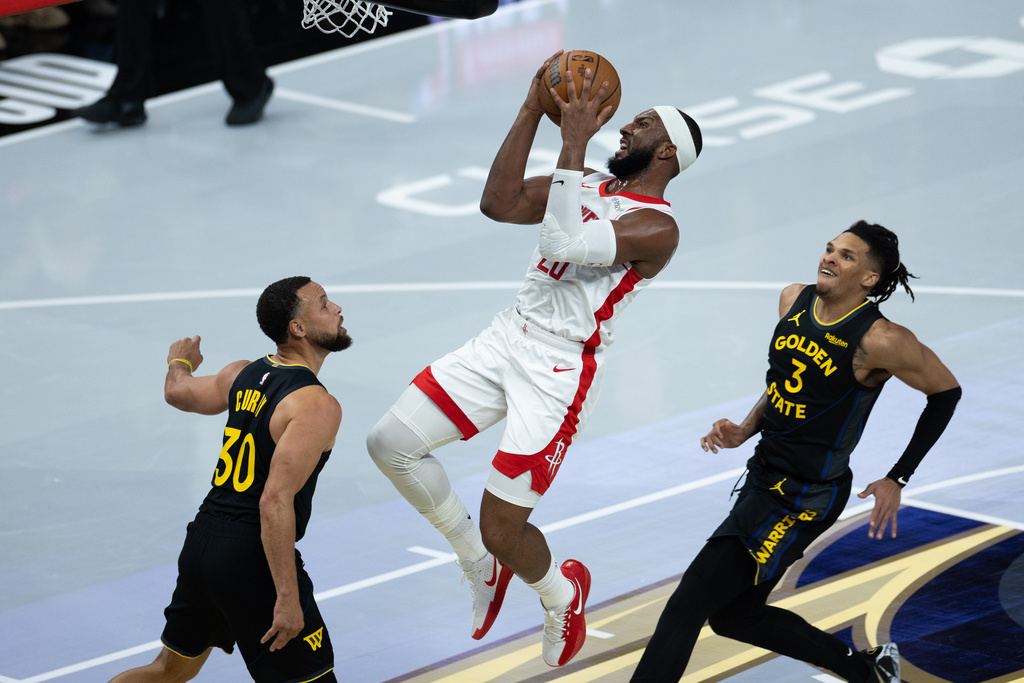 Houston Rockets guard Josh Okogie shoots past by Golden State Warriors guard Stephen Curry (30) during the first half of an Emirates NBA Cup basketball game, Wednesday, Nov. 26, 2025, in San Francisco. (AP Photo/Benjamin Fanjoy)