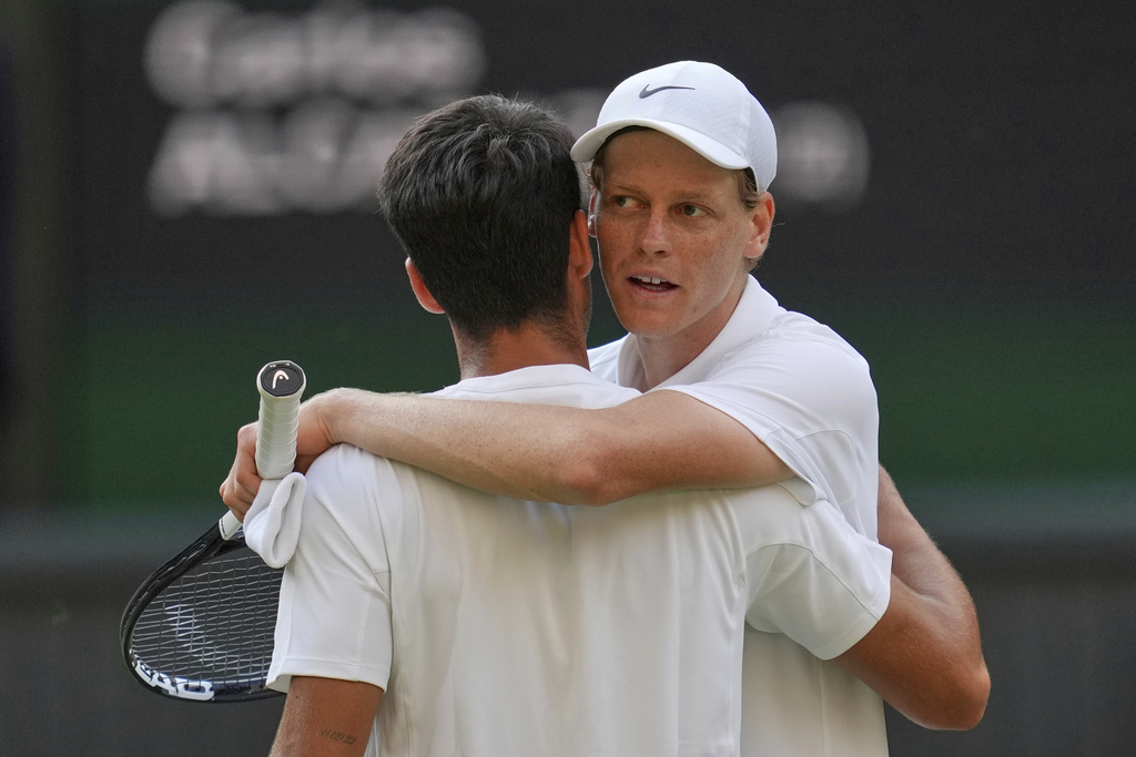 FILE - Italy's Jannik Sinner, right, greets Carlos Alcaraz, of Spain, at the net after beating him to win the men's singles final at the Wimbledon Tennis Championships in London, July 13, 2025. (AP Photo/Kin Cheung, File)