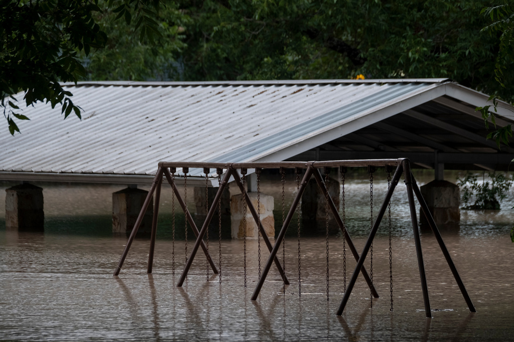 Water along the Pedernales River floods the Gillespie County Safety Rest Area on Thursday, July 16, 2026, in Stonewall, Texas. (AP Photo/Joel Angel Juarez)