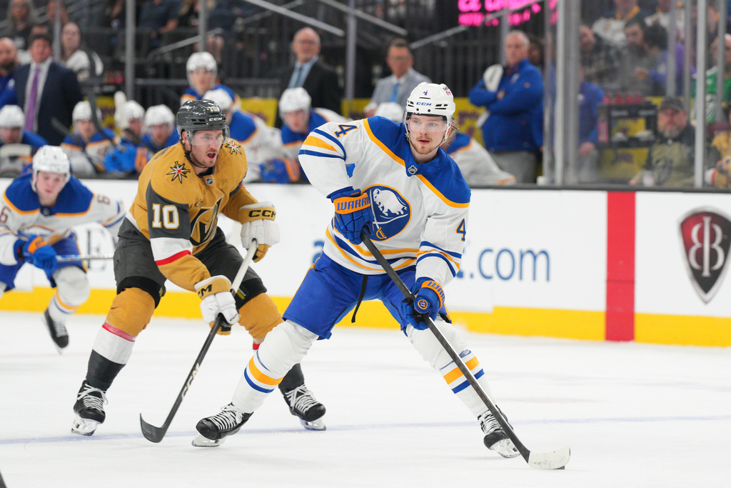 Buffalo Sabres defenseman Bowen Byram (4) skates with the puck against Vegas Golden Knights center Colton Sissons (10) during the first period of an NHL hockey game Tuesday, March 17, 2026, in Las Vegas. (AP Photo/Candice Ward)