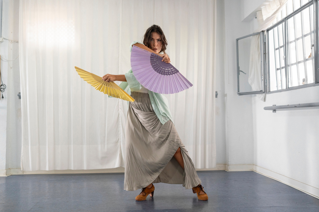 Carmen Torres, a professional flamenco dancer, rehearses a guajira, a flamenco style that traditionally incorporates the use of a fan, in Seville, Spain, on Aug. 27, 2026. (AP Photo/Laura Leon)