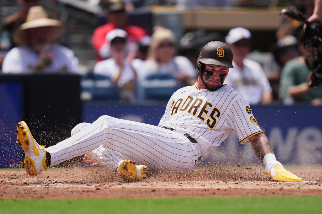 San Diego Padres' Jackson Merrill slides in to score from second base off an RBI single by Luis Rengifo during the second inning of a baseball game against the Pittsburgh Pirates Wednesday, Aug. 26, 2026, in San Diego. (AP Photo/Gregory Bull)