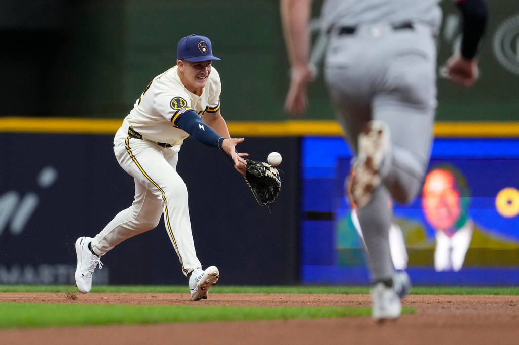 Milwaukee Brewers' Cooper Pratt tosses the ball to second base to start a double play during the second inning of a baseball game against the Cleveland Guardians, Tuesday, June 16, 2026, in Milwaukee. (AP Photo/Aaron Gash)