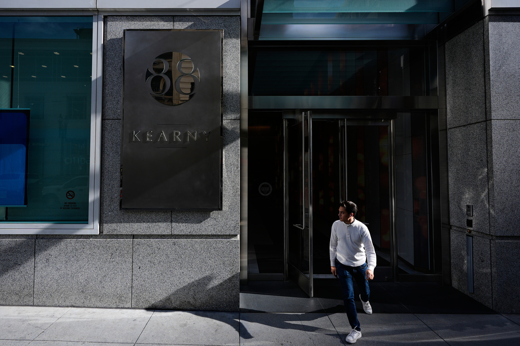 A man walks out of the 88 Kearny Street building, where KCBS Radio is located, Wednesday, Dec. 3, 2025, in San Francisco. (AP Photo/Godofredo A. Vásquez)