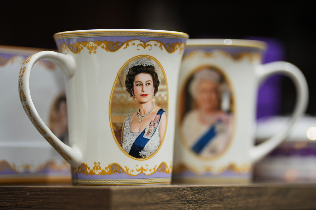 Mugs with photos of late Queen Elizabeth II are on display for sale at a souvenirs shop in London, on April 17, 2026. (AP Photo/Kin Cheung)