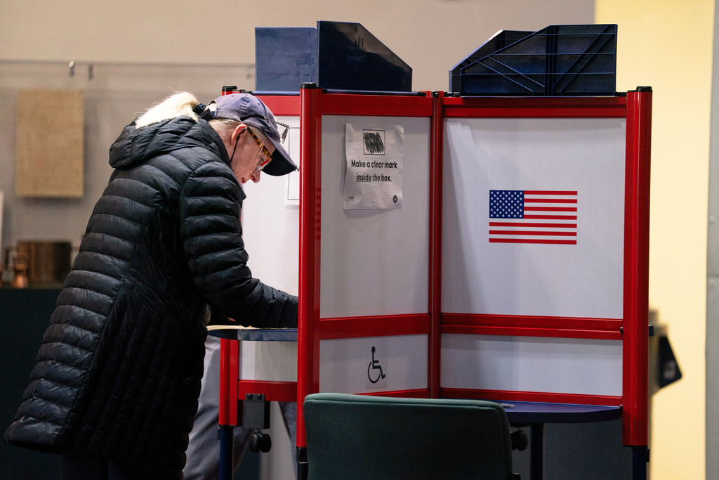 A voter completes her ballot at Alexandria City Hall, Tuesday, Nov. 4, 2025, in Alexandria, Va. (AP Photo/Allison Robbert)