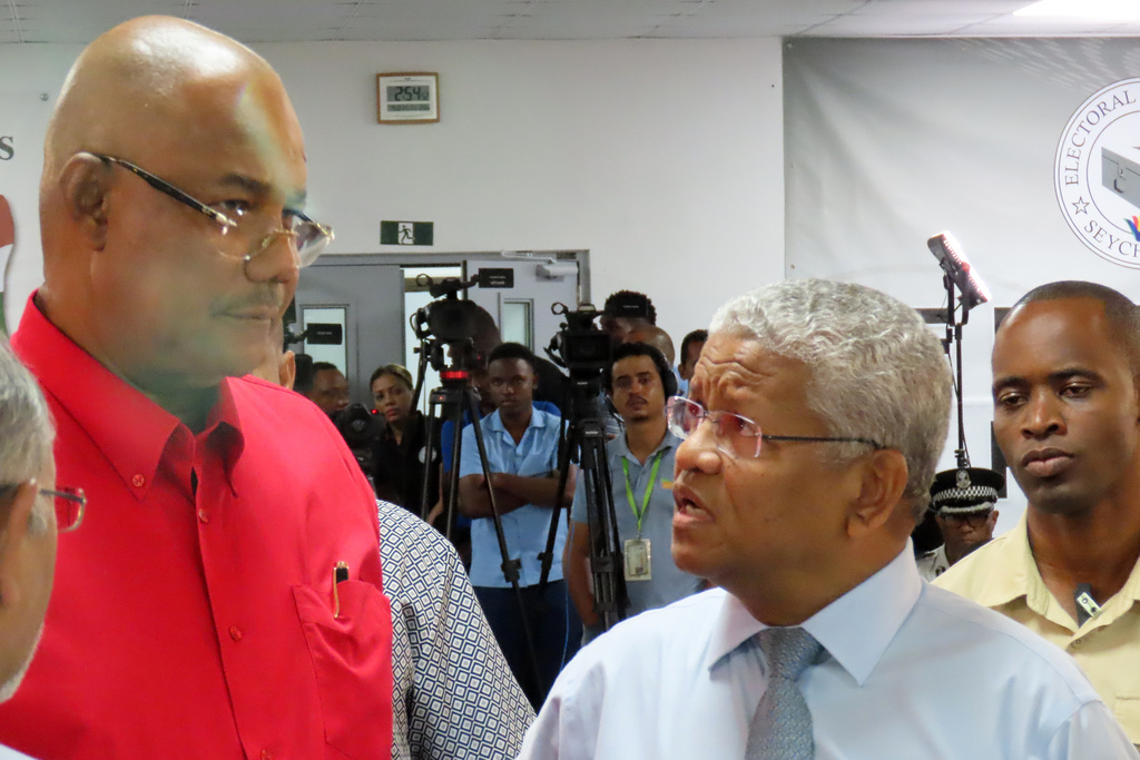 President-elect Patrick Herminie, left, speaks with incumbent leader Wavel Ramkalawan, right, after winning in the runoff presidential election at Mont Fleuri Secondary School polling station in Victoria, Seychelles, on Sunday, Oct. 12, 2025. (AP Photo/Emilie Chetty)