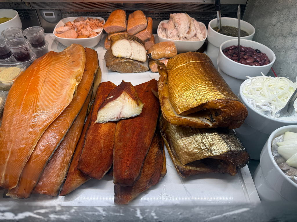 Various smoked fish are displayed behind the counter at Tal Bagels in New York on Sept. 13, 2026. (Katie Workman via AP)