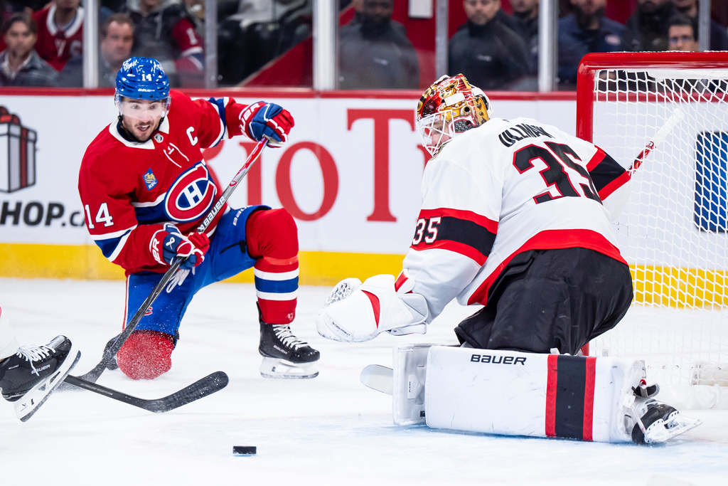 Ottawa Senators goaltender Linus Ullmark (35) makes save against Montreal Canadiens' Nick Suzuki (14) during the first period NHL hockey game in Montreal, Tuesday, Dec. 2, 2025. (Christopher Katsarov/The Canadian Press via AP)