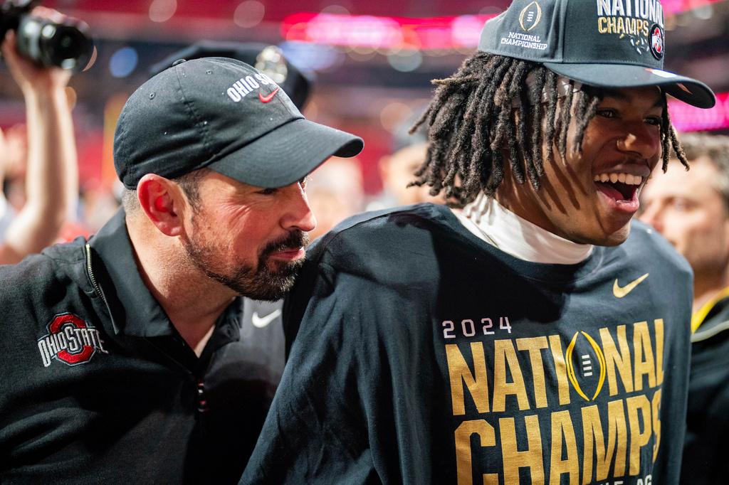 FILE - Ohio State head coach Ryan Day and Ohio State wide receiver Jeremiah Smith (4) celebrate after defeating Notre Dame during the College Football Playoff national championship game, on Jan. 20, 2025, in Atlanta. (AP Photo/Jacob Kupferman, File)