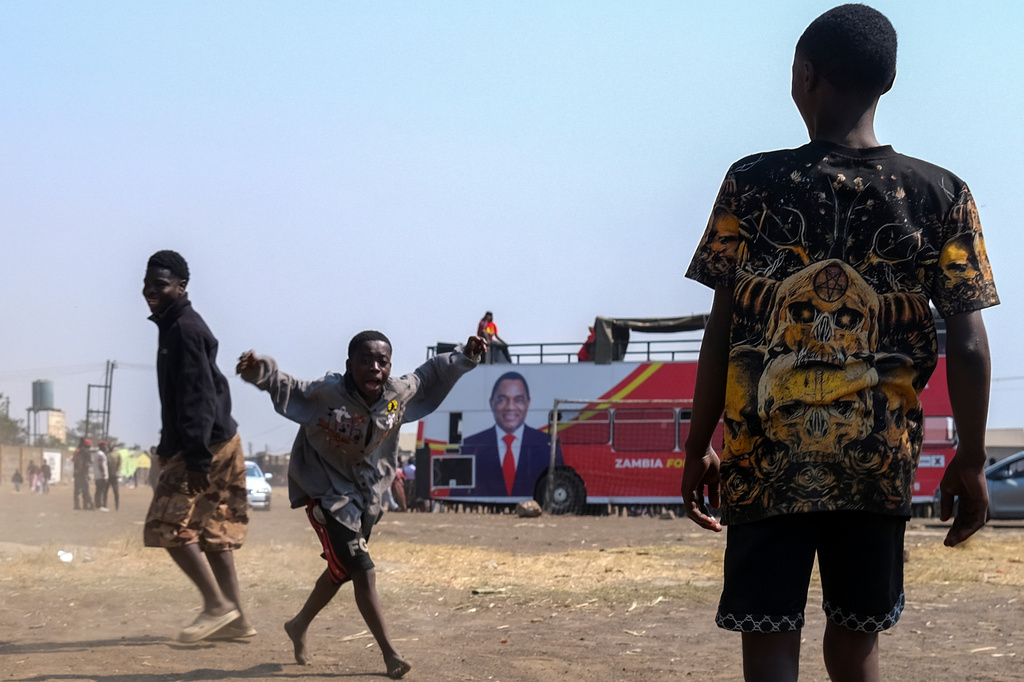 Supporters of Zambian incumbent President and United Party for National Development (UPND) presidential candidate Hakainde Hichilema attend a campaign rally on the outskirts of Lusaka, Zambia, Saturday, Aug. 8, 2026. (AP Photo/Anita Reed)