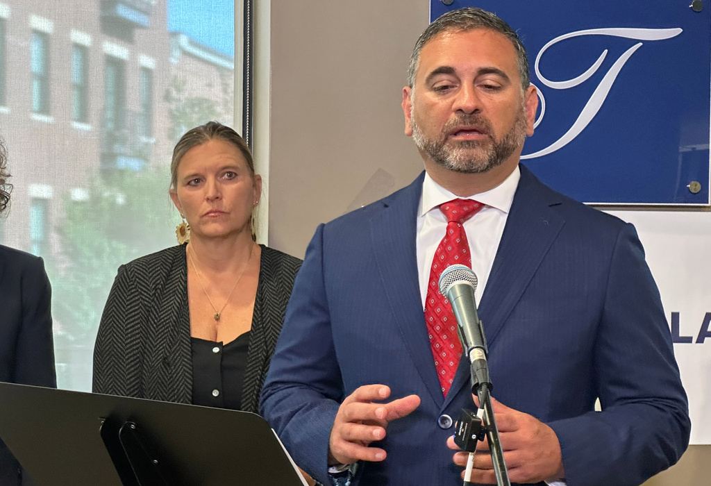 Tad Thomas, a lawyer for the family of Henry Willis, right, speaks at a news conference while Willis' mother, Laura Herp, looks on Thursday, July 16, 2026, in Louisville, Ky. (AP Photo/Dylan Lovan)