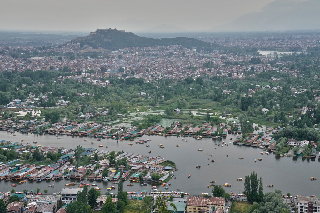 Boats maneuver the waters of Dal Lake in Srinagar, Indian controlled Kashmir, Thursday, June 4, 2026. (AP Photo/Dar Yasin)