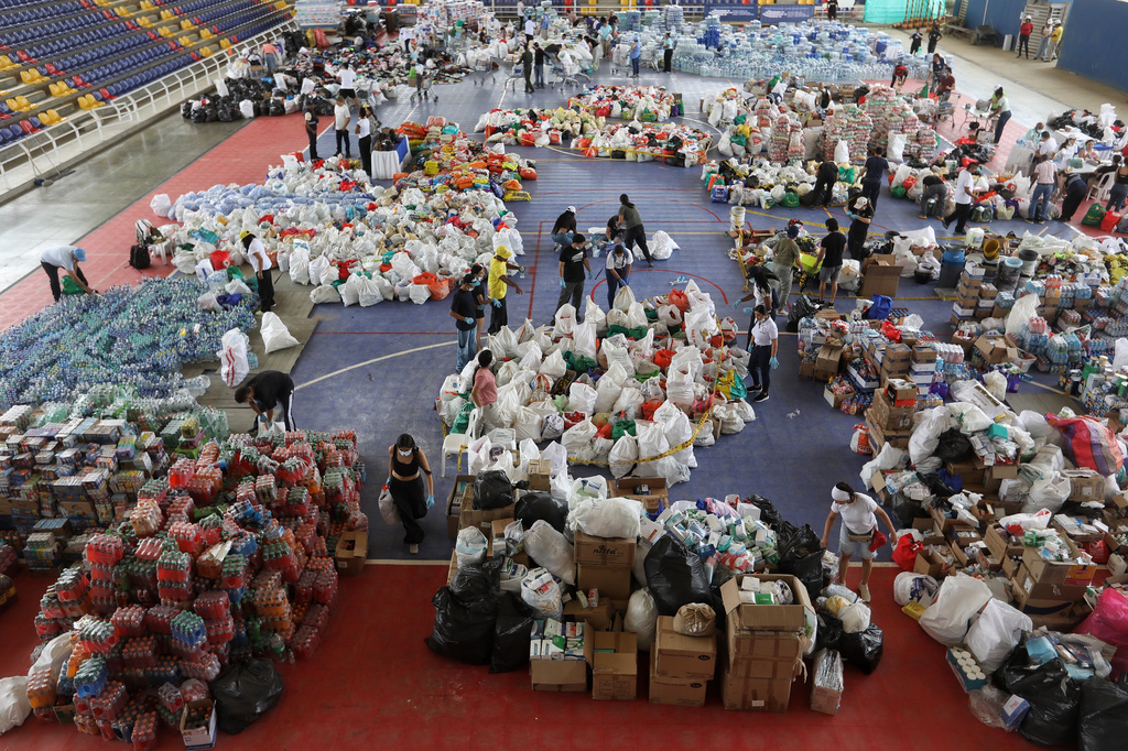 Volunteers sort aid for people affected by the earthquake in Cali, Colombia, Wednesday, Aug. 12, 2026. (AP Photo/Santiago Saldarriaga)